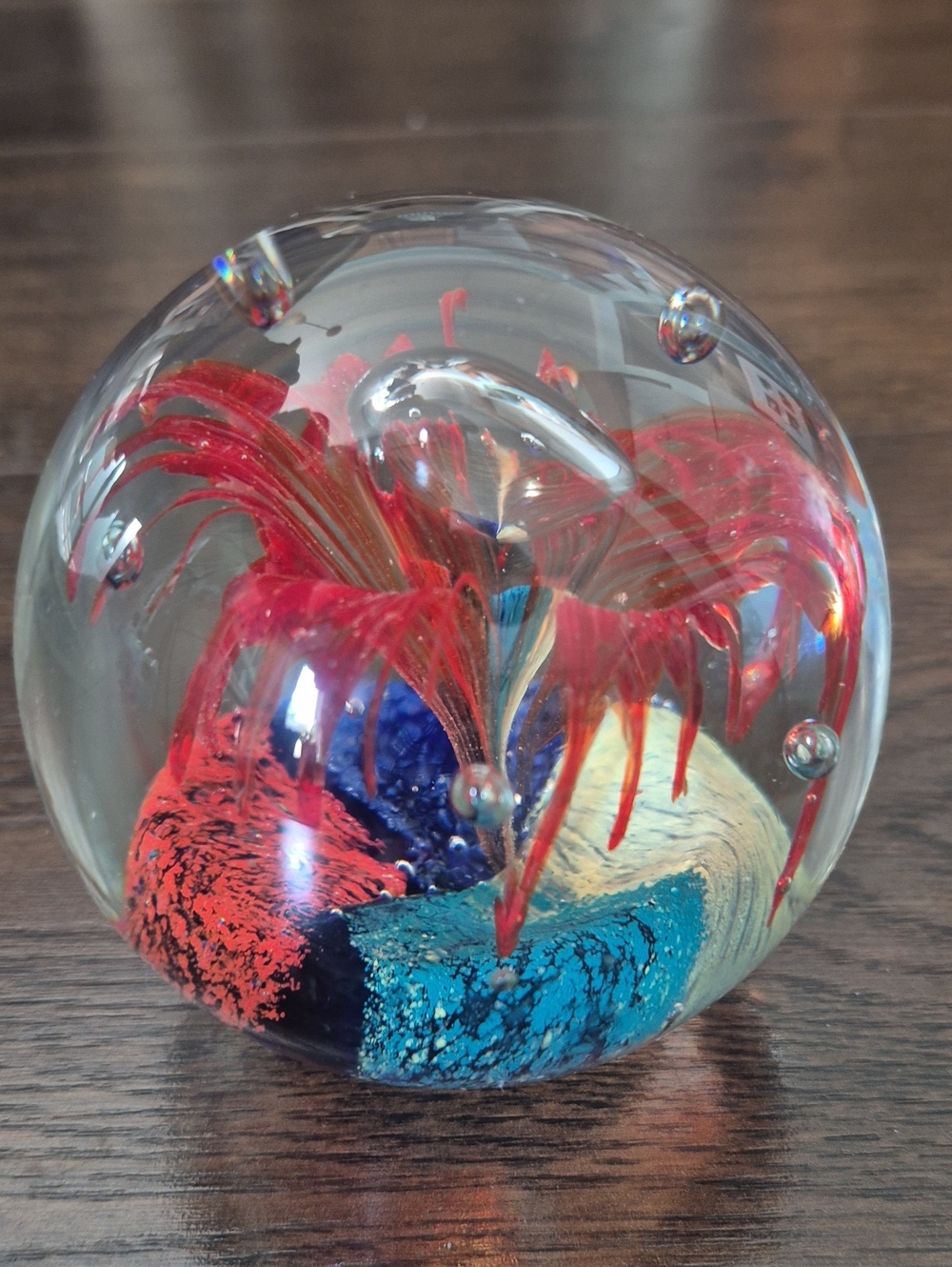 Red Flower Burst On Multi Color Base W/ Bubbles Paper Weight.